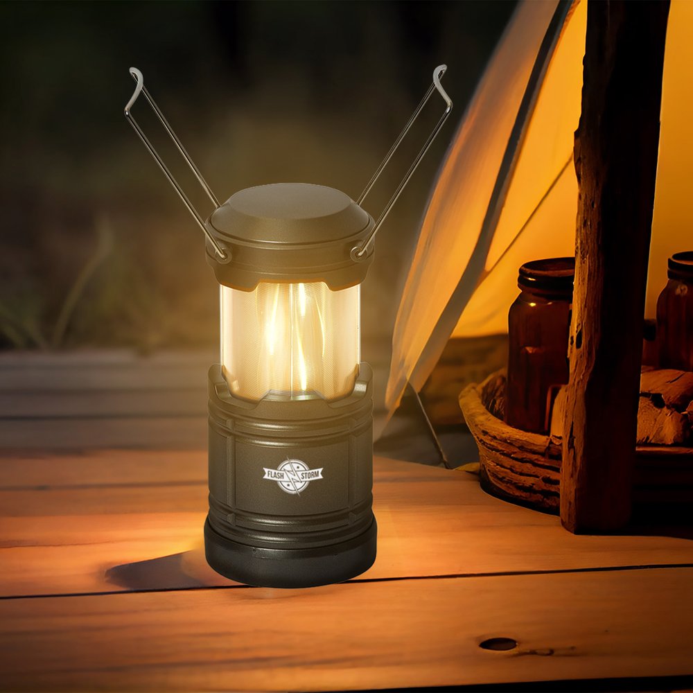 Glowing pop-up lantern beside a tent