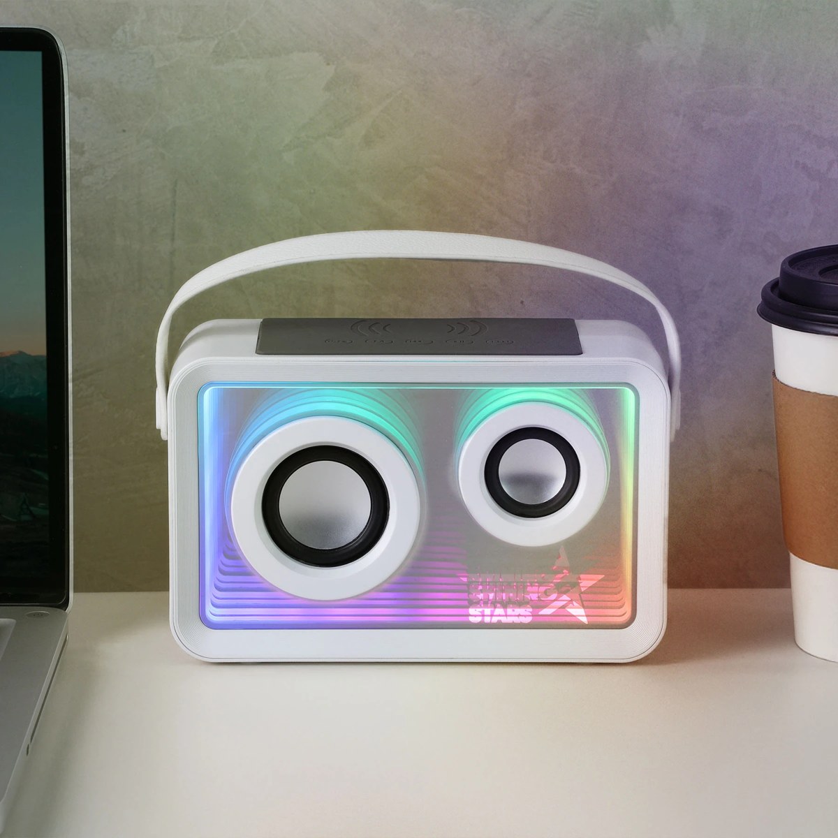Light-up wireless speaker with a charging pad on top