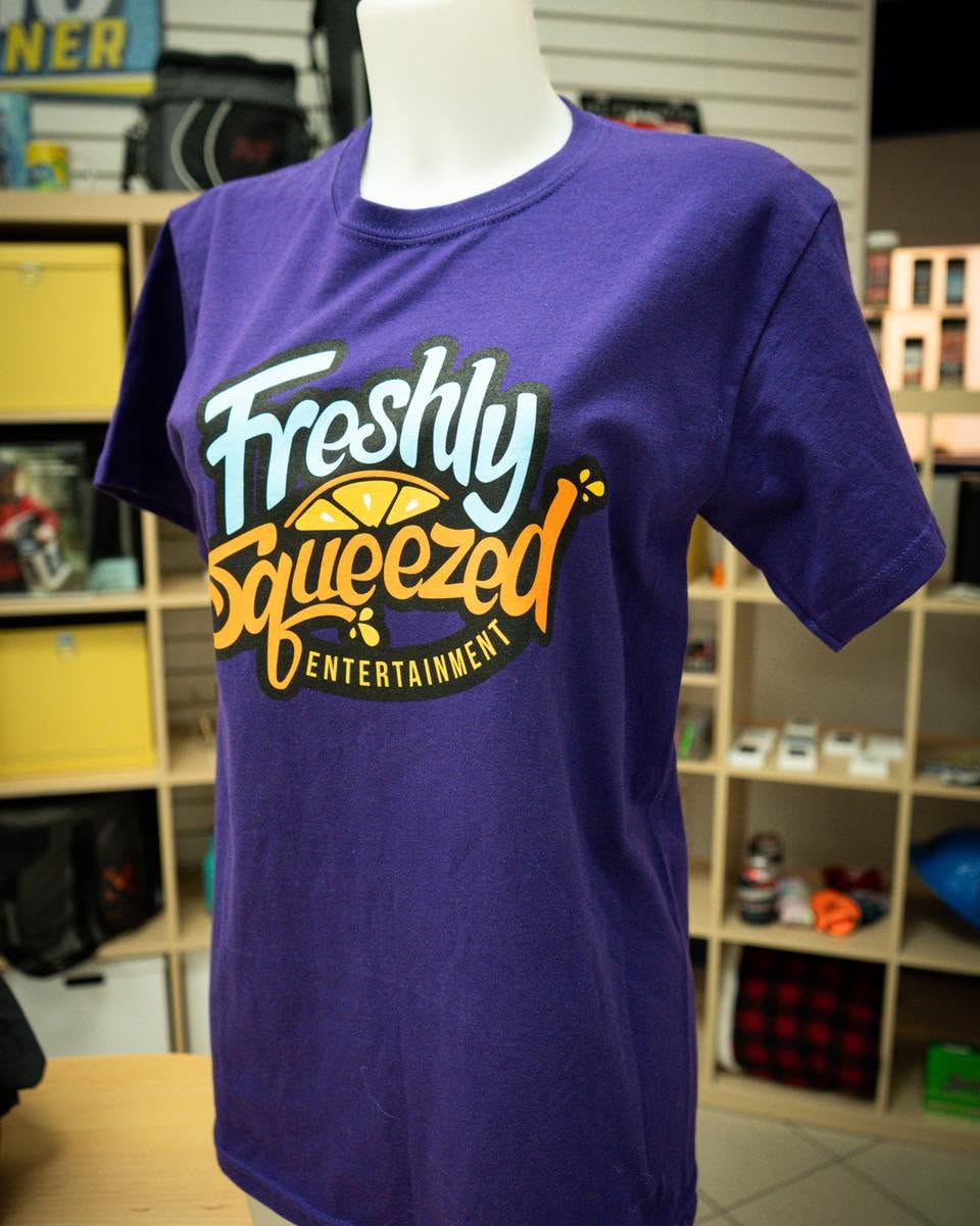 Multi-colour screen printed Freshly Squeezed Entertainment logo on a purple t-shirt